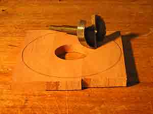 Forstner bit and piece of wood with centre drilled