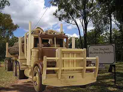 Wooden logging truck model superimposed into real photo.